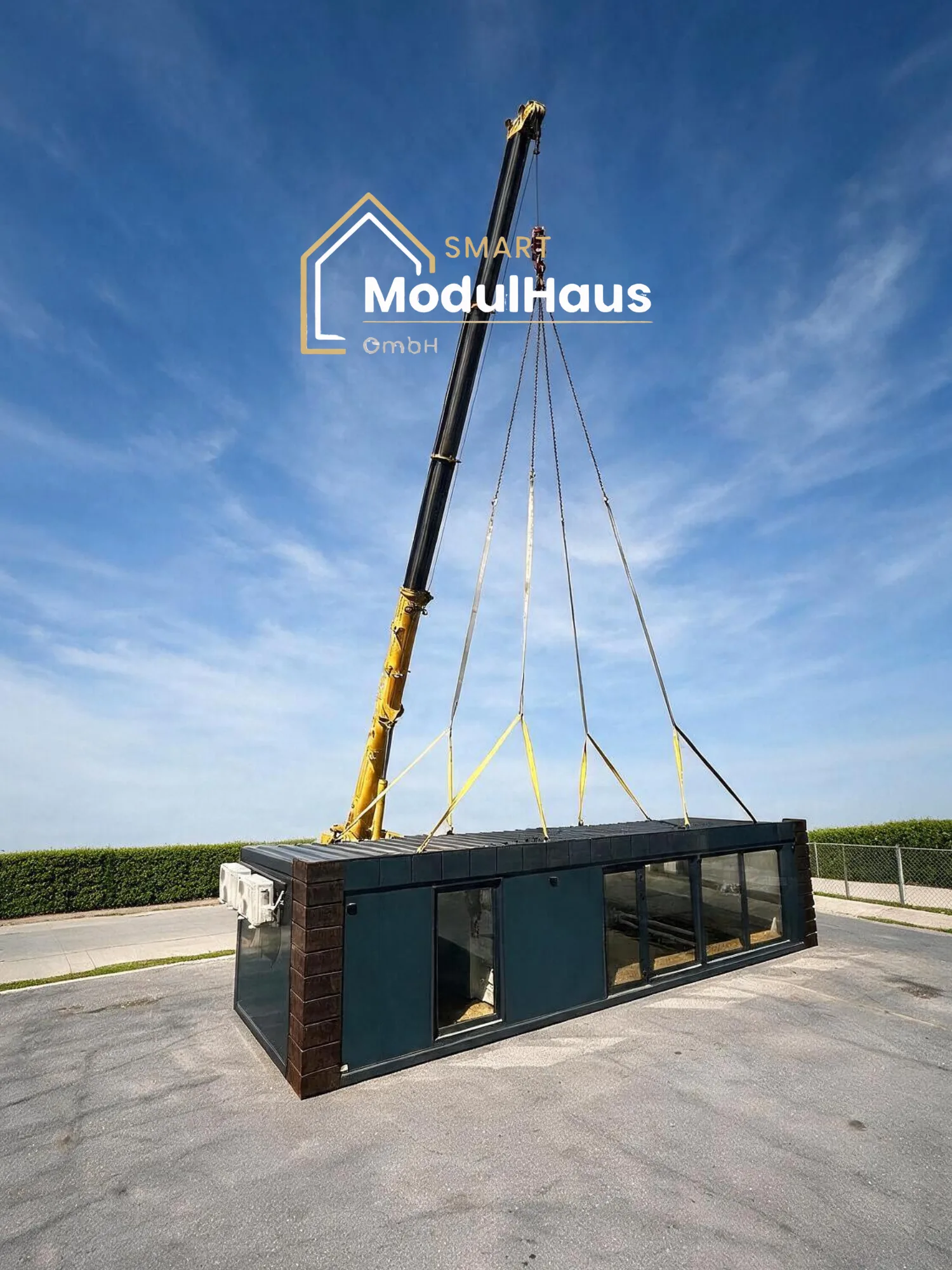 Fertiges Modulhaus wird auf dem Werksgelände mit dem Kran zum Transport verladen